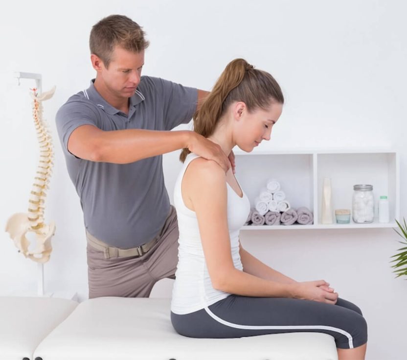 2 Chiropractor adjusting patients neck